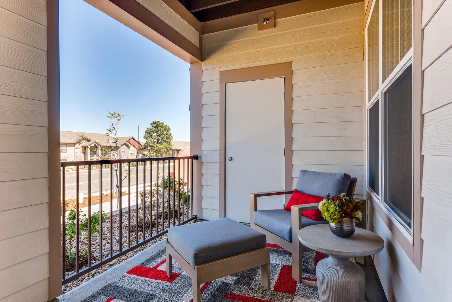a small balcony with a chair and a table