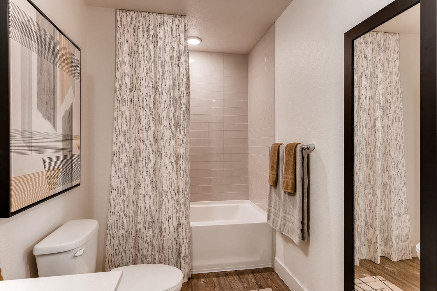 a bathroom with a shower and a toilet and a sink