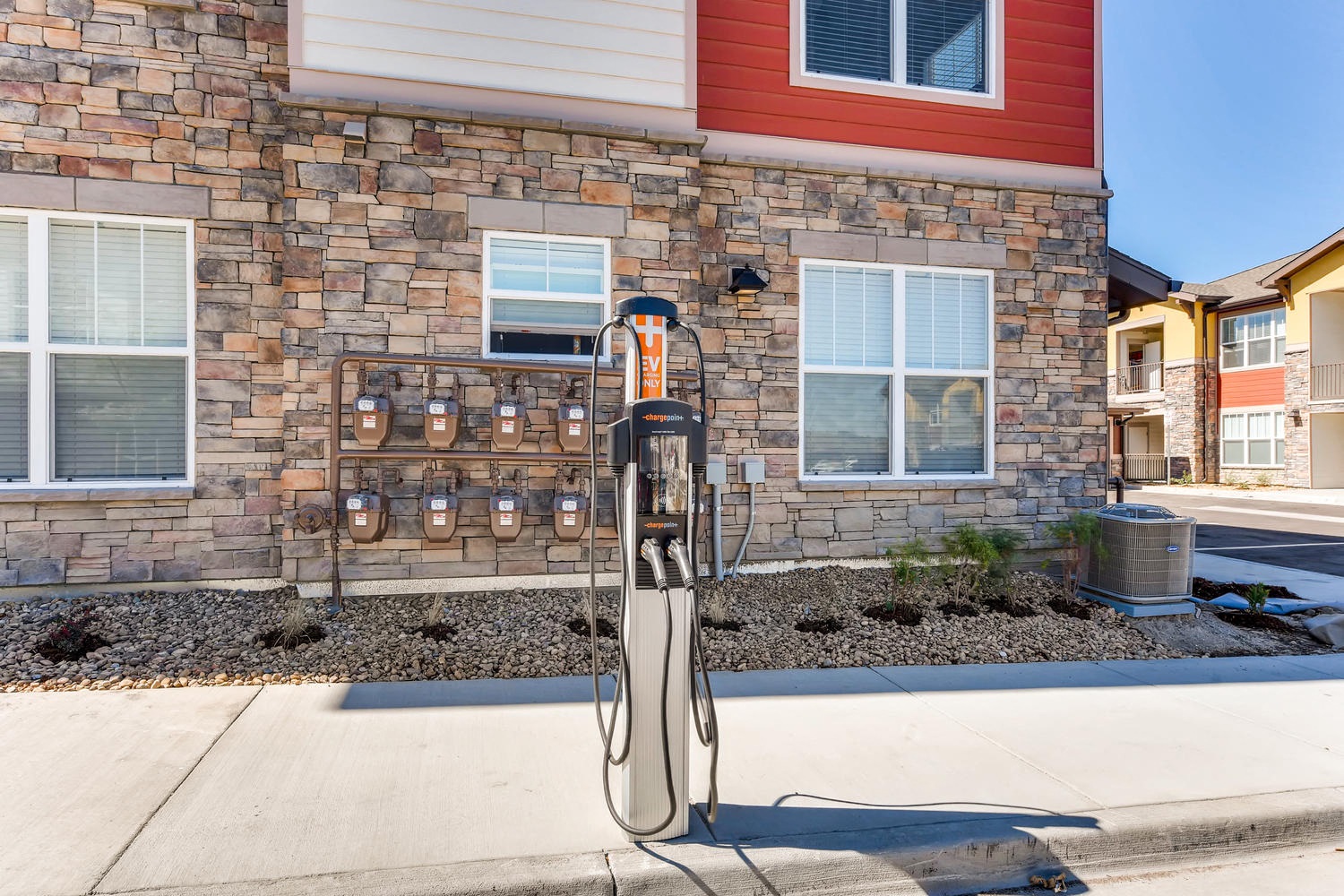 a gas pump in front of a brick building