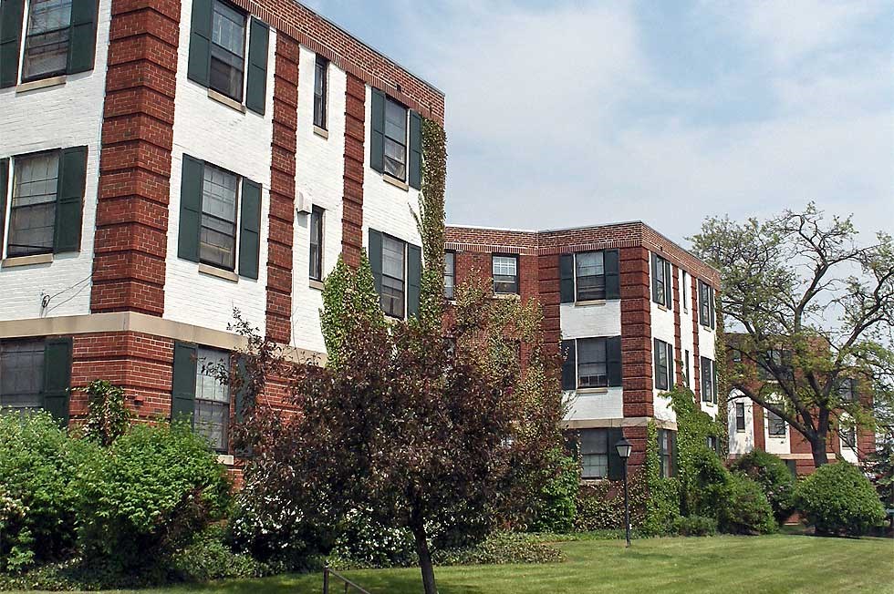 a group of brick and white apartment buildings