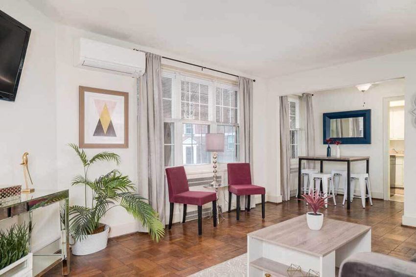 a living room with a couch and chairs and a dining room table