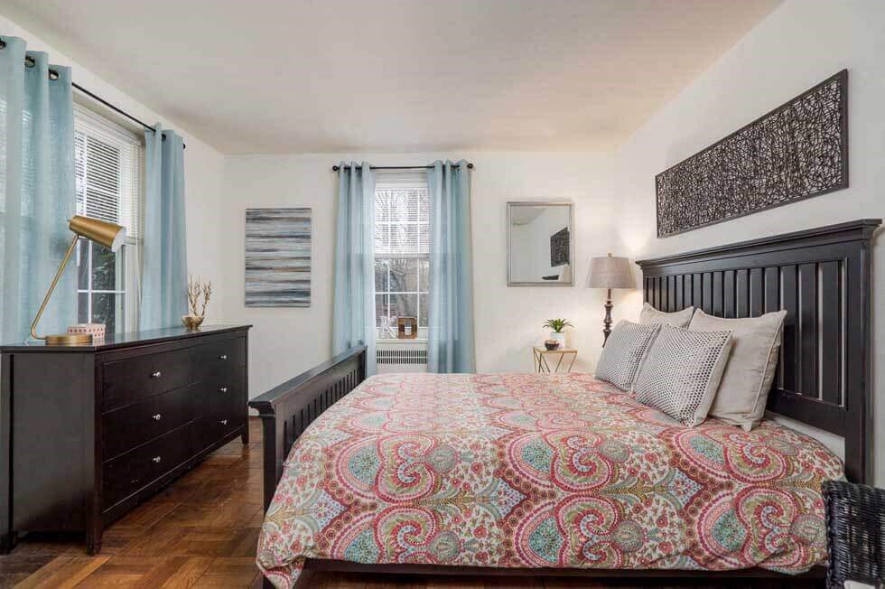 a bedroom with a bed and a dresser