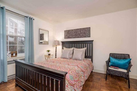 a bedroom with a bed and a window