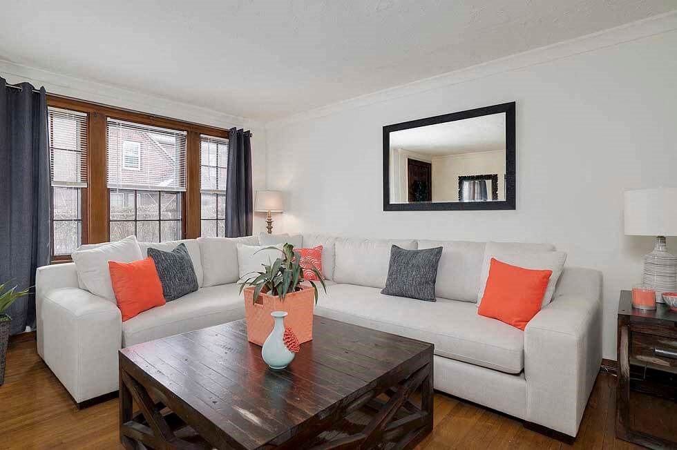 a living room with a white couch and a wooden table