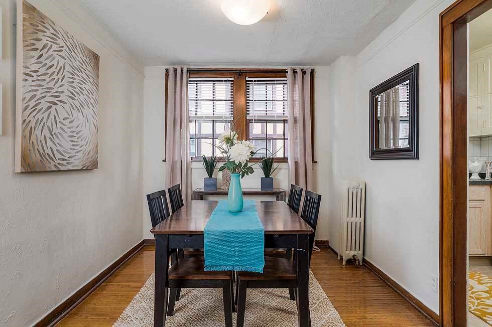a dining room with a wooden table and chairs