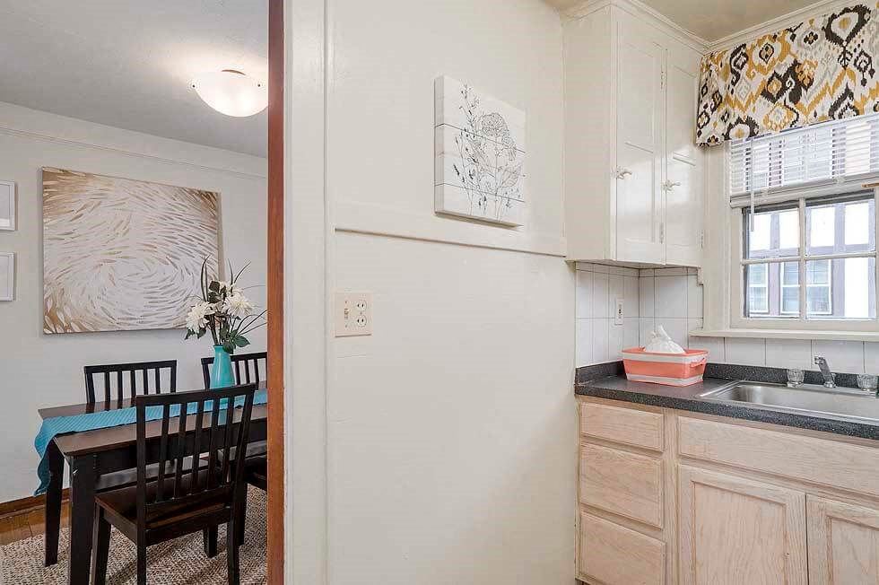 a kitchen and dining room with a table and a refrigerator