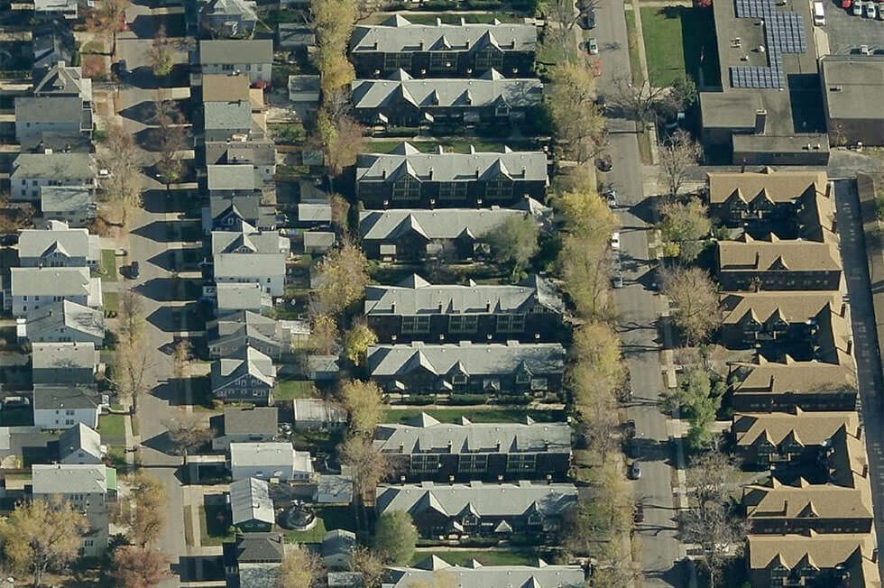 an aerial view of a suburb of houses and trees