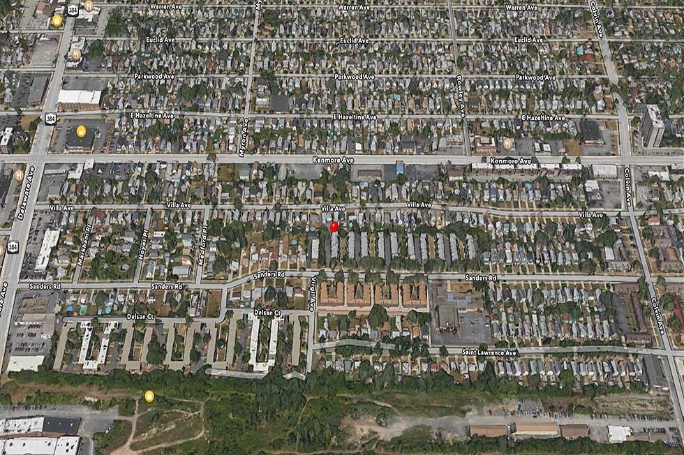 an aerial view of a city with a red dot