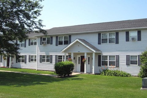 a large white house with a lawn in front of it