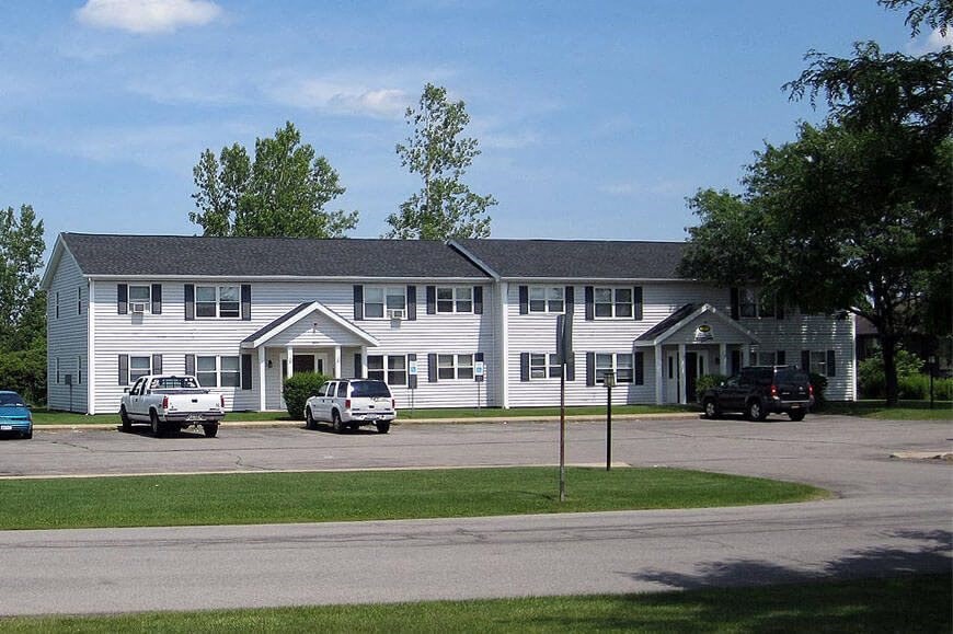 a large white building with cars parked in front of it