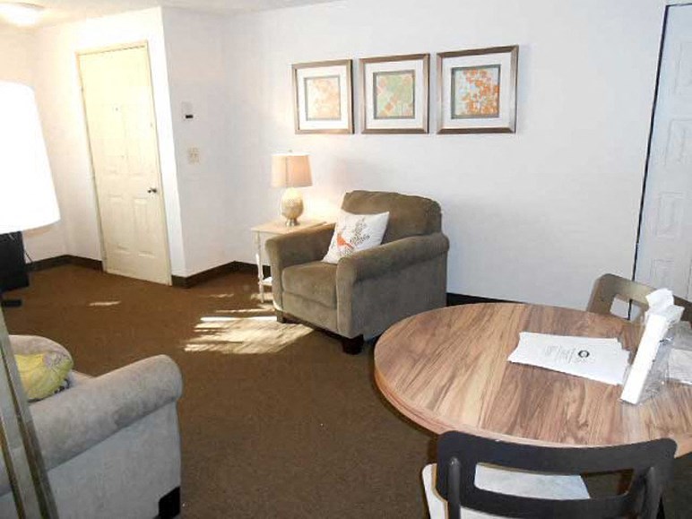 a living room with two chairs and a table