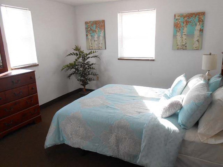 a bedroom with a bed and a dresser