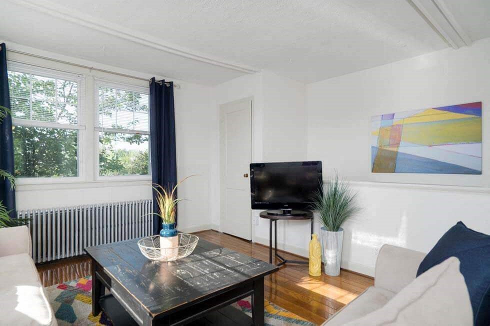 a living room with a television and a table