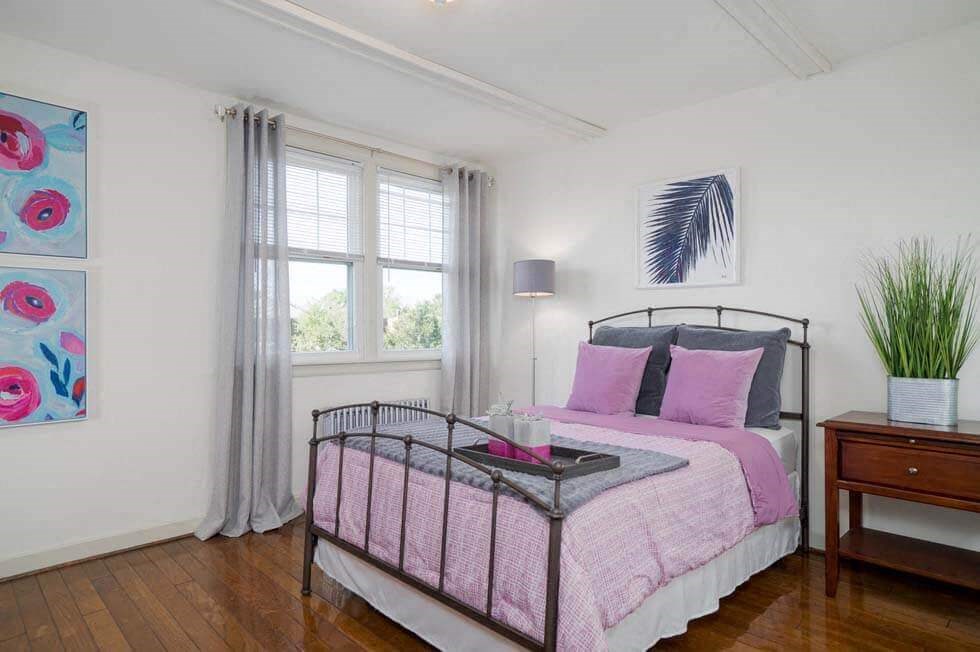 a bedroom with a bed and a window