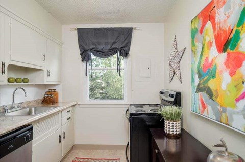 a small kitchen with a sink and a window