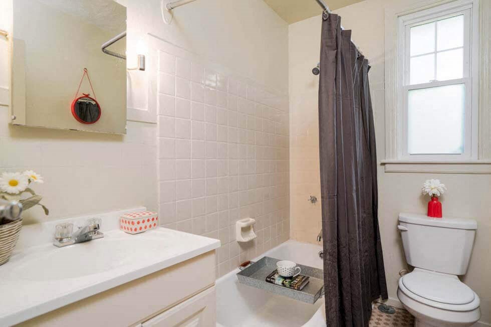 a bathroom with a shower and a toilet and a sink