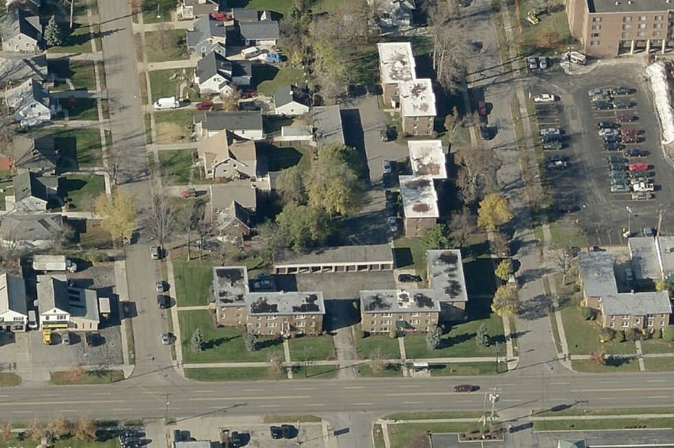 an aerial view of houses and cars in a suburban neighborhood