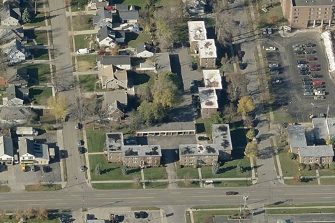 an aerial view of houses and cars in a suburban neighborhood