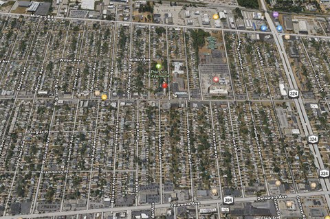 an aerial view of a city with many houses and trees