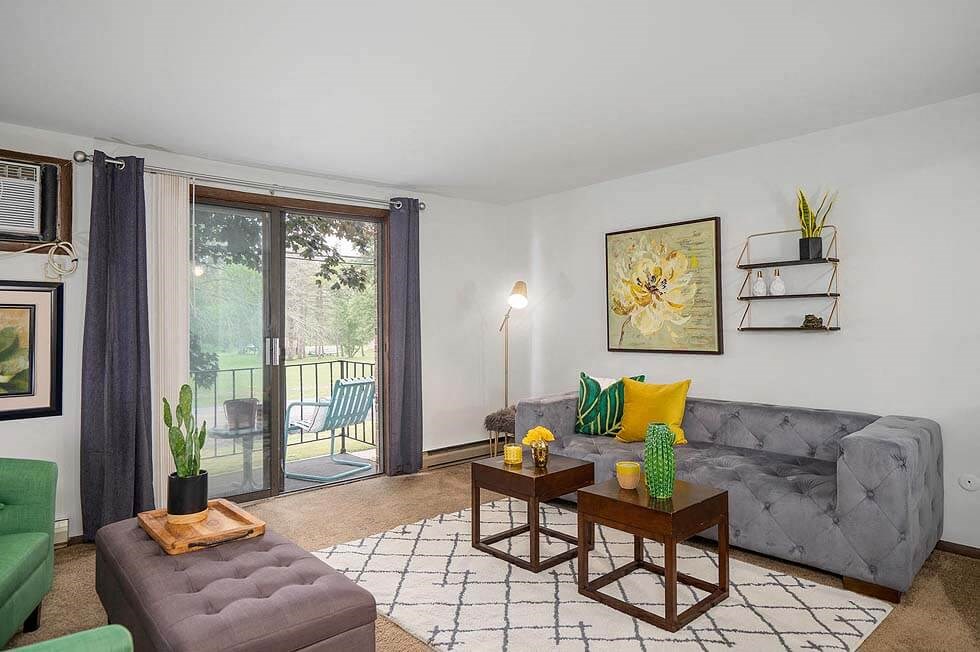 a living room with a couch and a sliding glass door