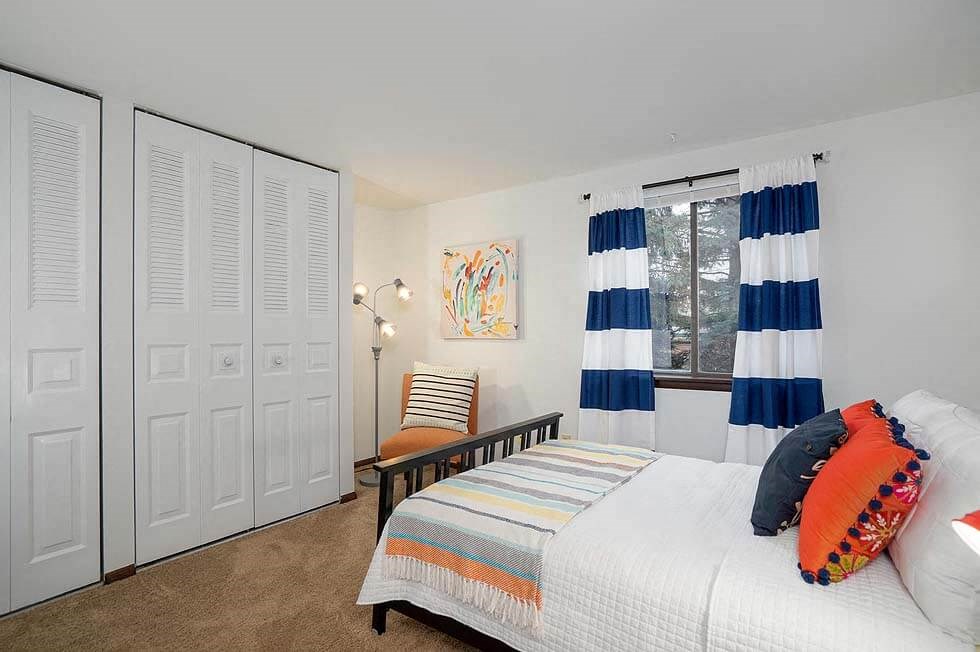 a bedroom with a bed and a window