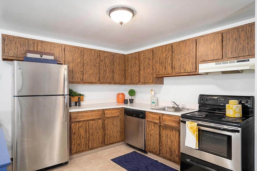 a kitchen with stainless steel appliances and wooden cabinets