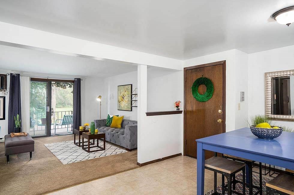 a living room with a blue table and a couch