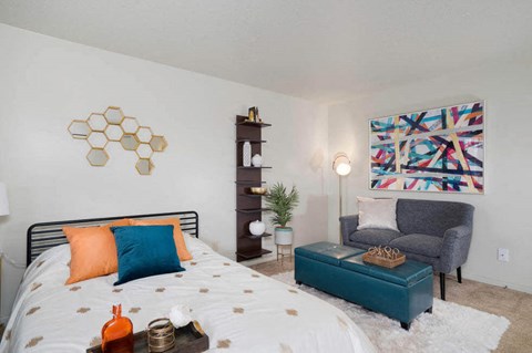a bedroom with a bed and a living room with a couch