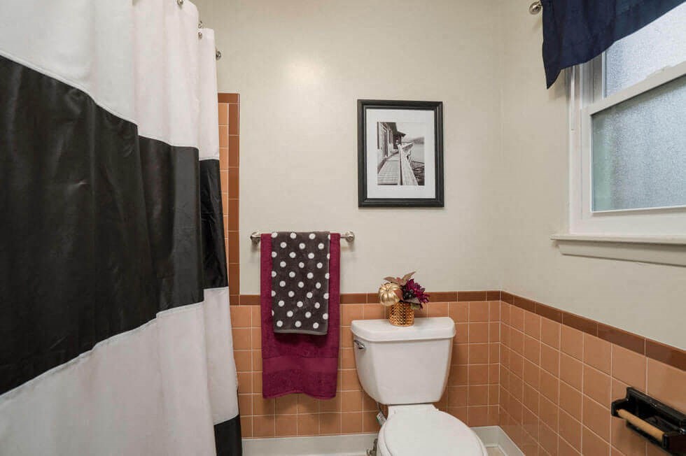 a bathroom with a toilet and a shower curtain