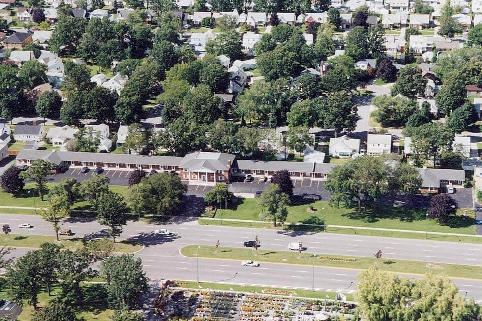 an aerial view of a neighborhood with a parking lot