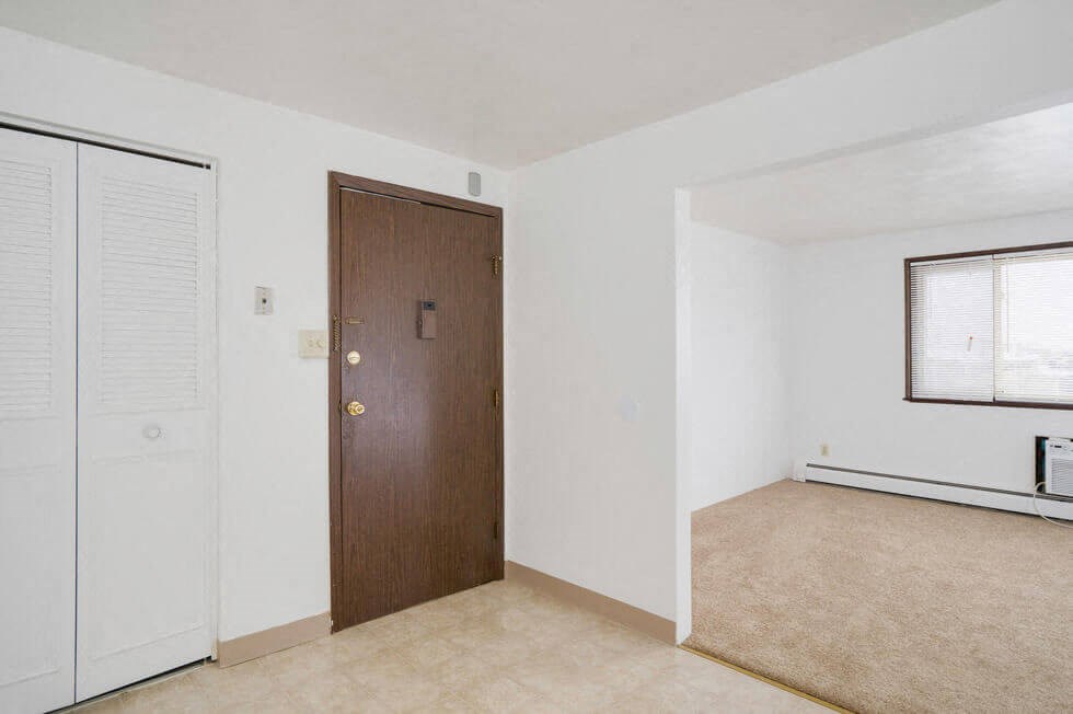 an empty room with a door in the middle of it