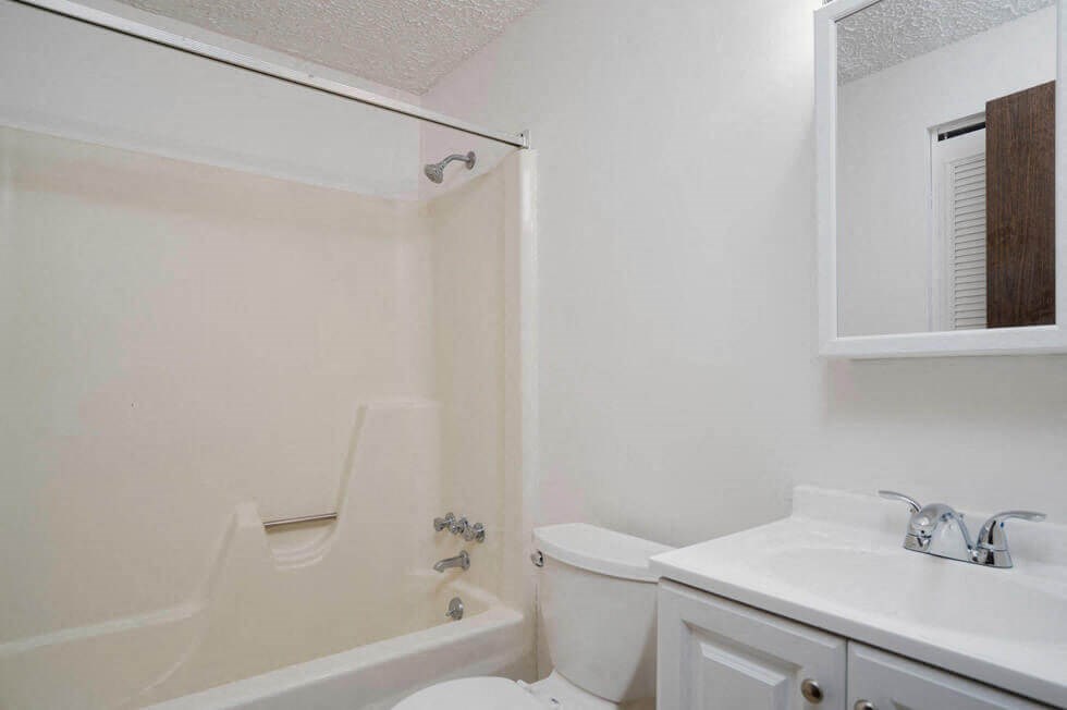 a bathroom with a sink toilet and a bath tub