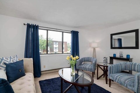 a living room with blue and white furniture and a large window