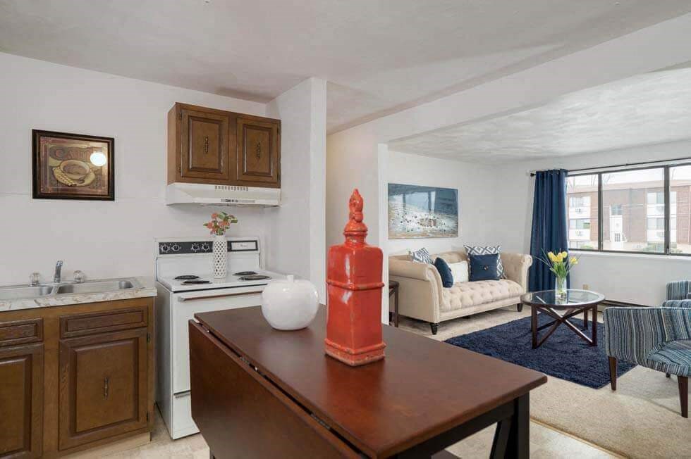 a living room with a kitchen and a table