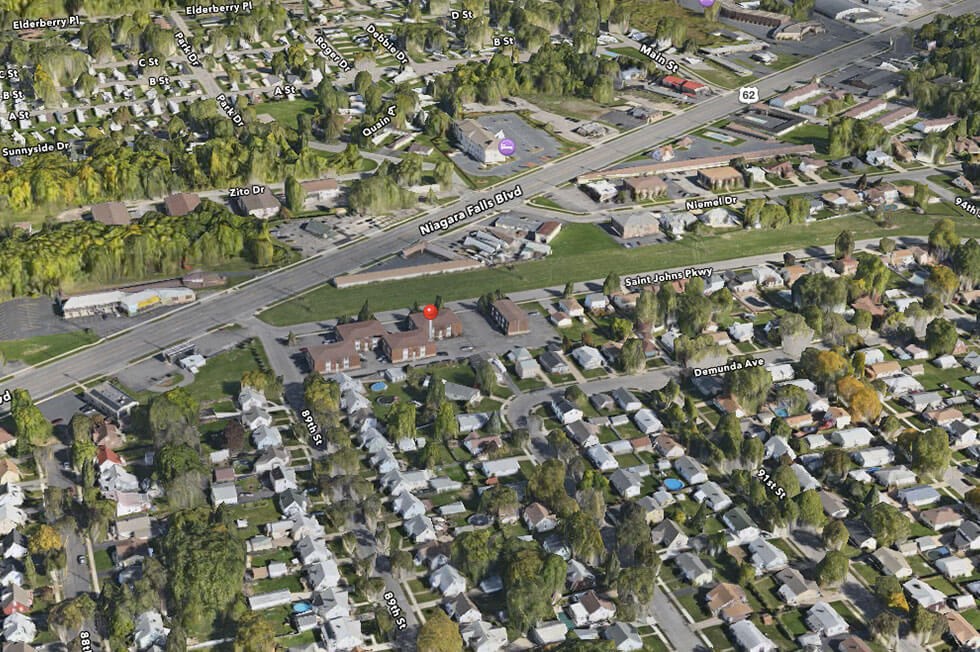 an aerial view of a suburb of a city with houses and trees