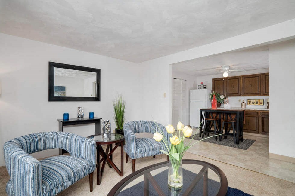 a living room with two chairs and a glass table