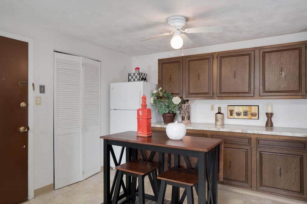 a kitchen with a table and some stools