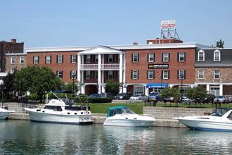 three boats are docked in the water in front of a building