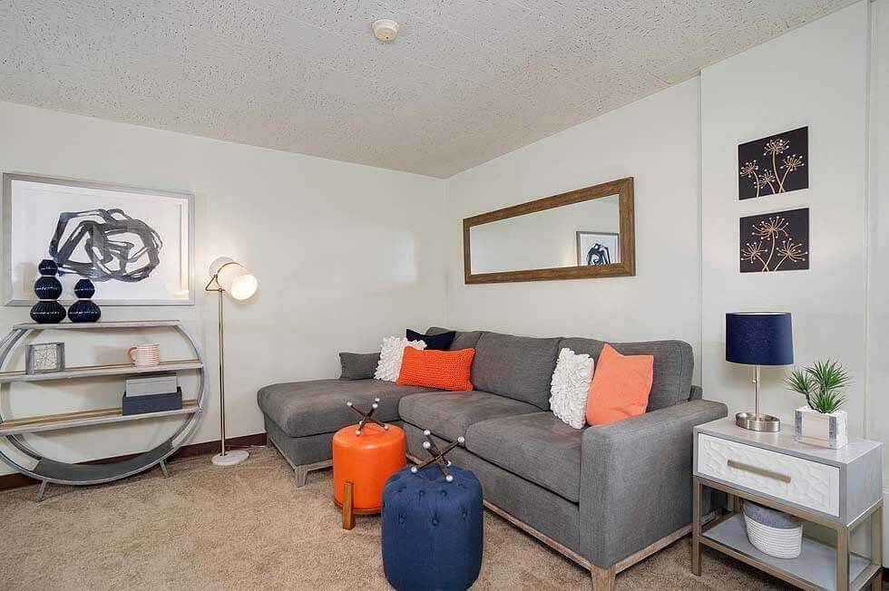 a living room with a couch and a suitcase