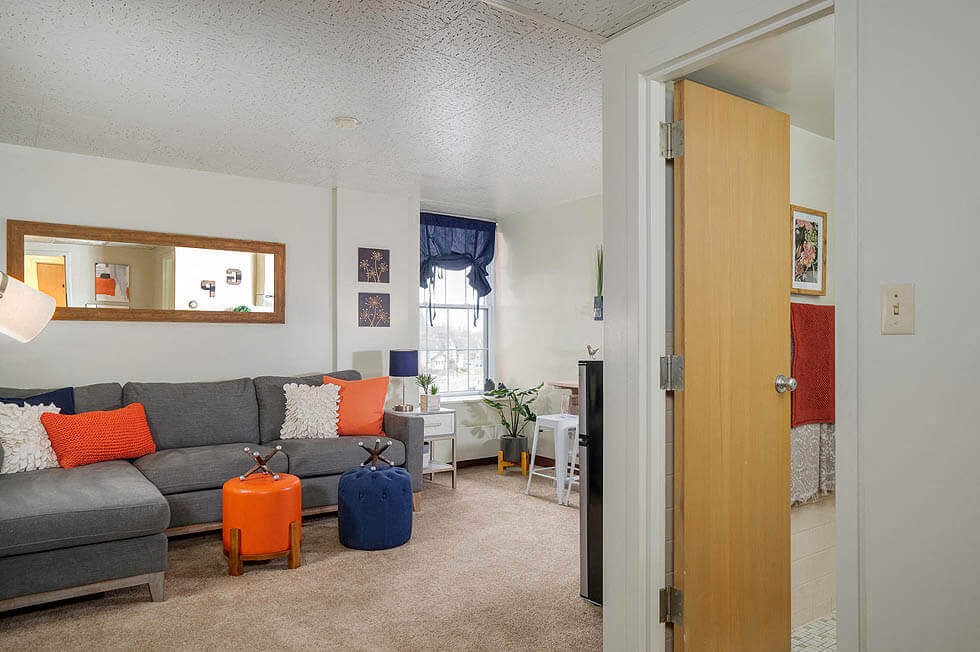 a living room with a couch and luggage