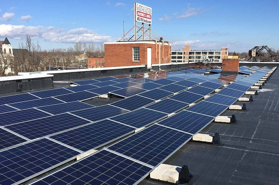 a group of solar panels on the roof of a building