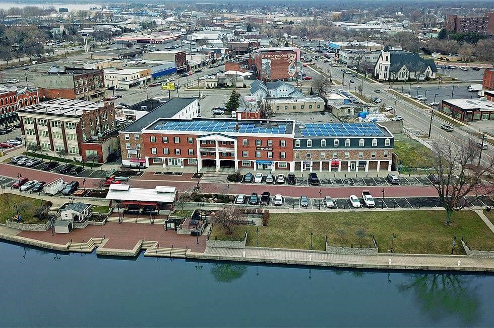 an aerial view of a city with a body of water