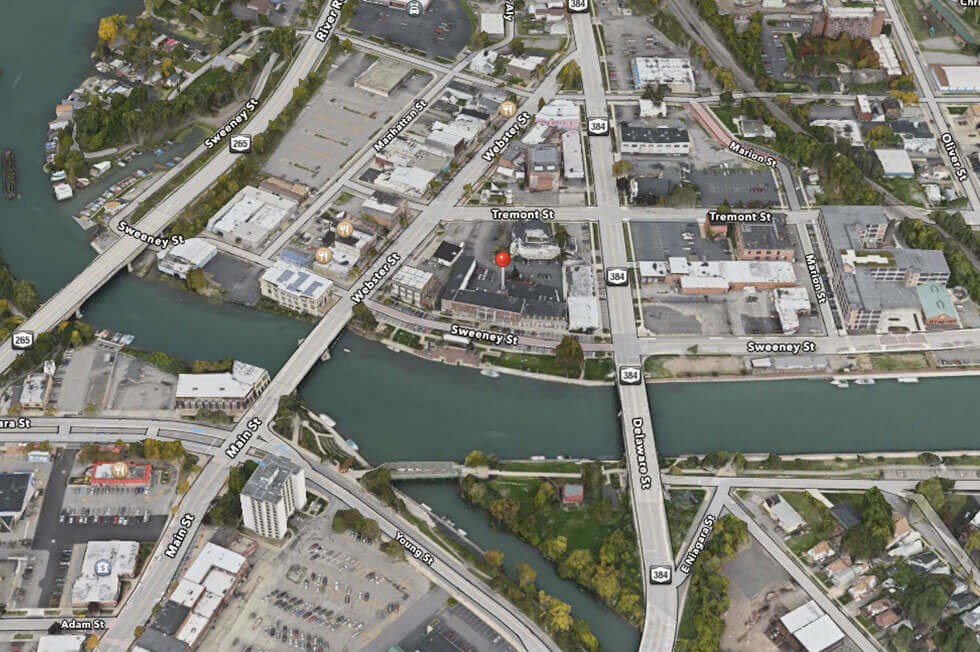 an aerial view of a city with a river and buildings