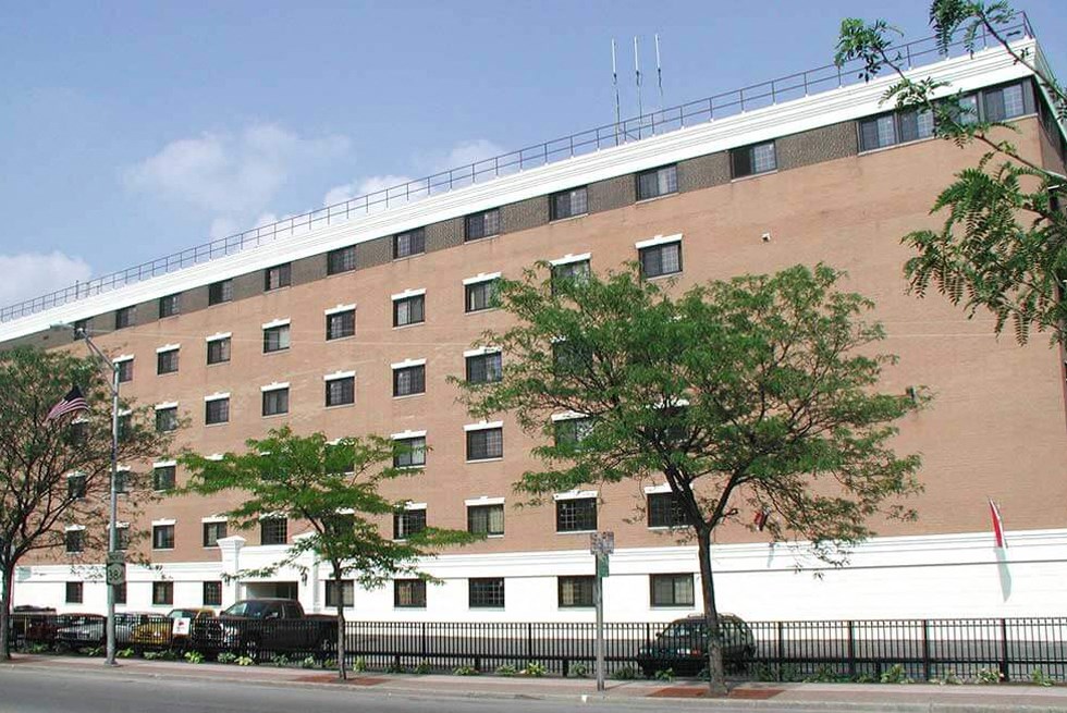 a large brick building with trees in front of it