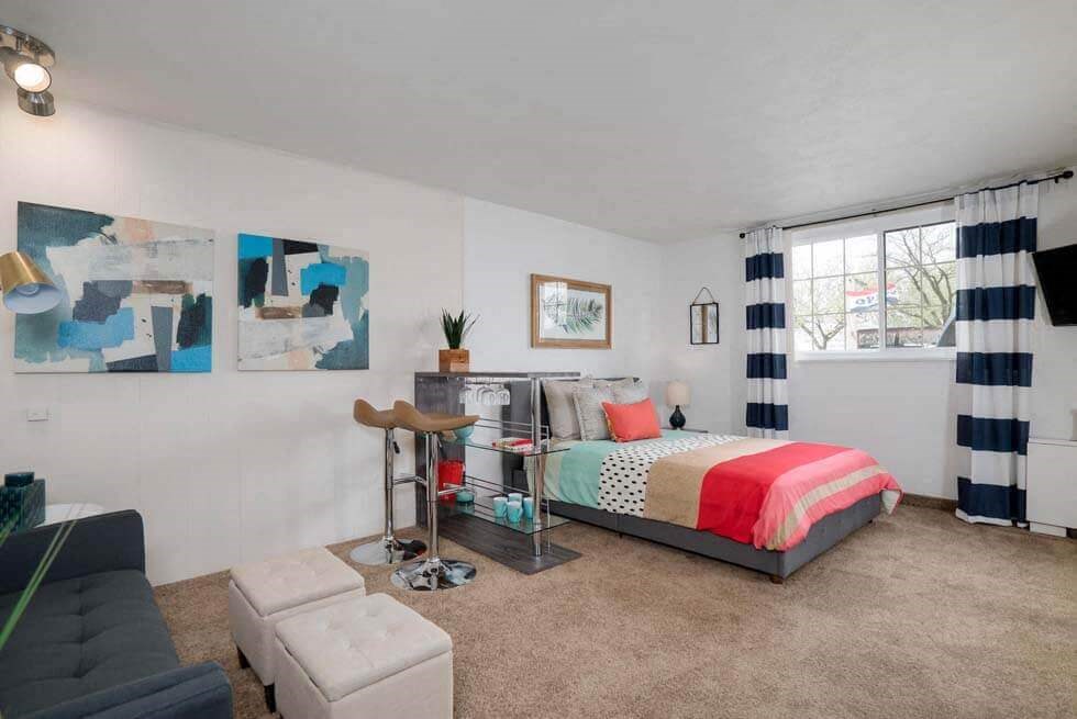 a bedroom with a bed and a couch