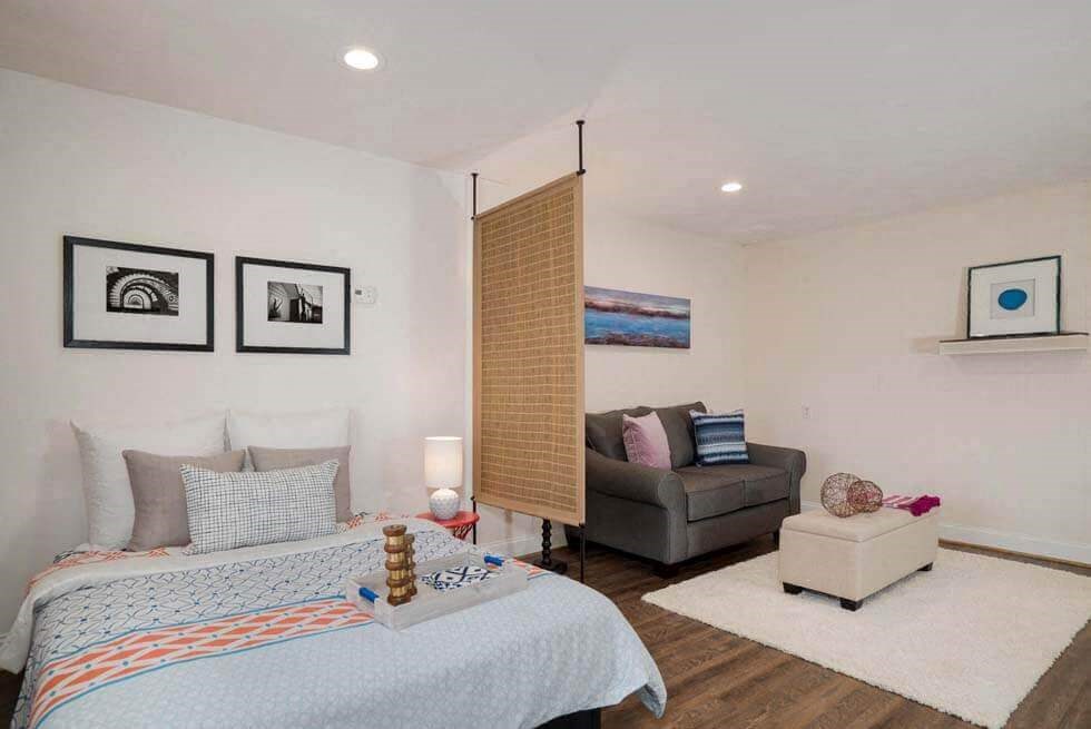 a bedroom with a bed and a couch