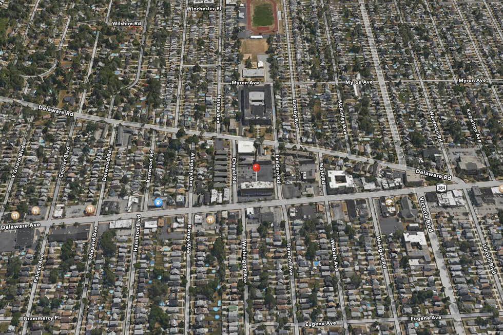 a satellite view of a city with a red dot