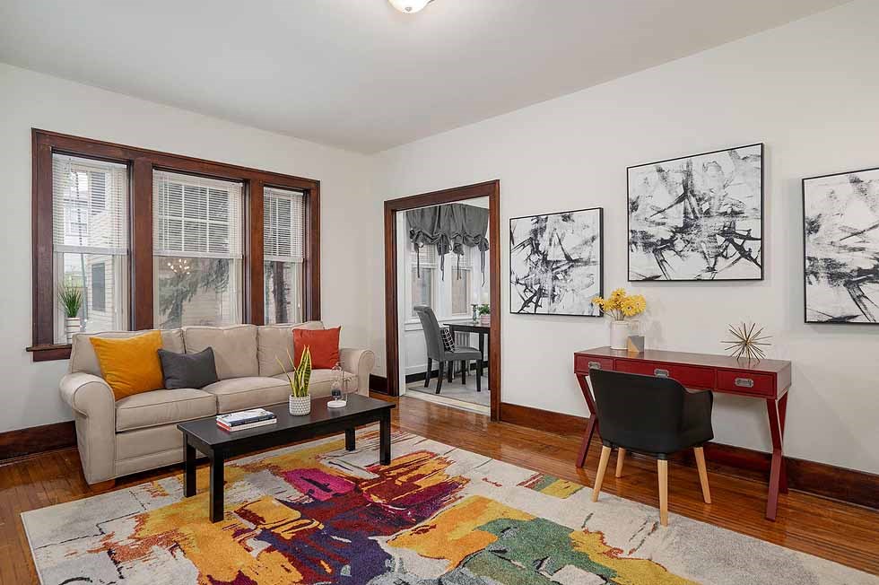 a living room with a couch and a red desk