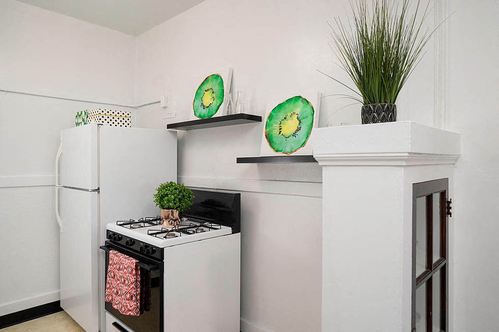 a kitchen with a stove and a refrigerator