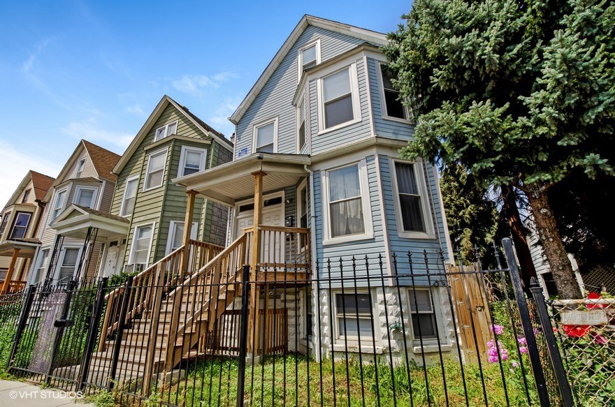 a row of houses with a fence in front of them